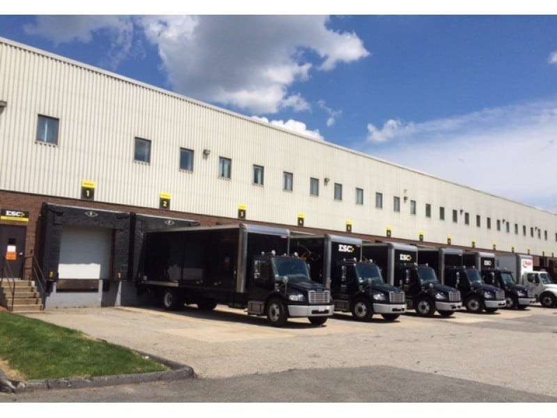 distribution trucks getting loaded with products