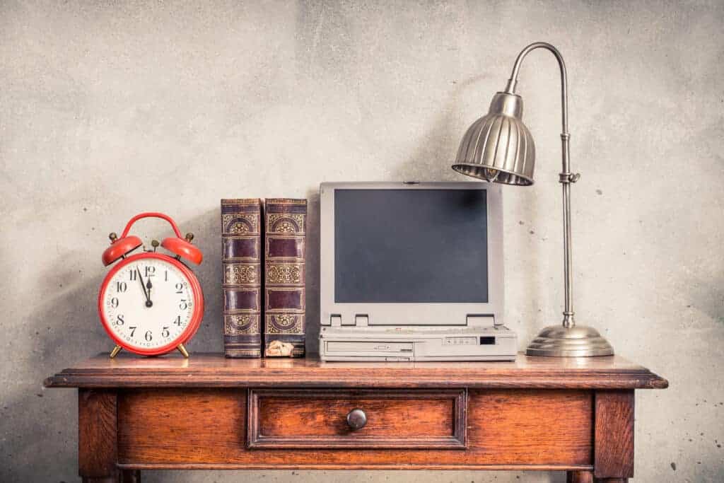 A picture of an old computer and alarm clock.Don't get stuck using outdated software!